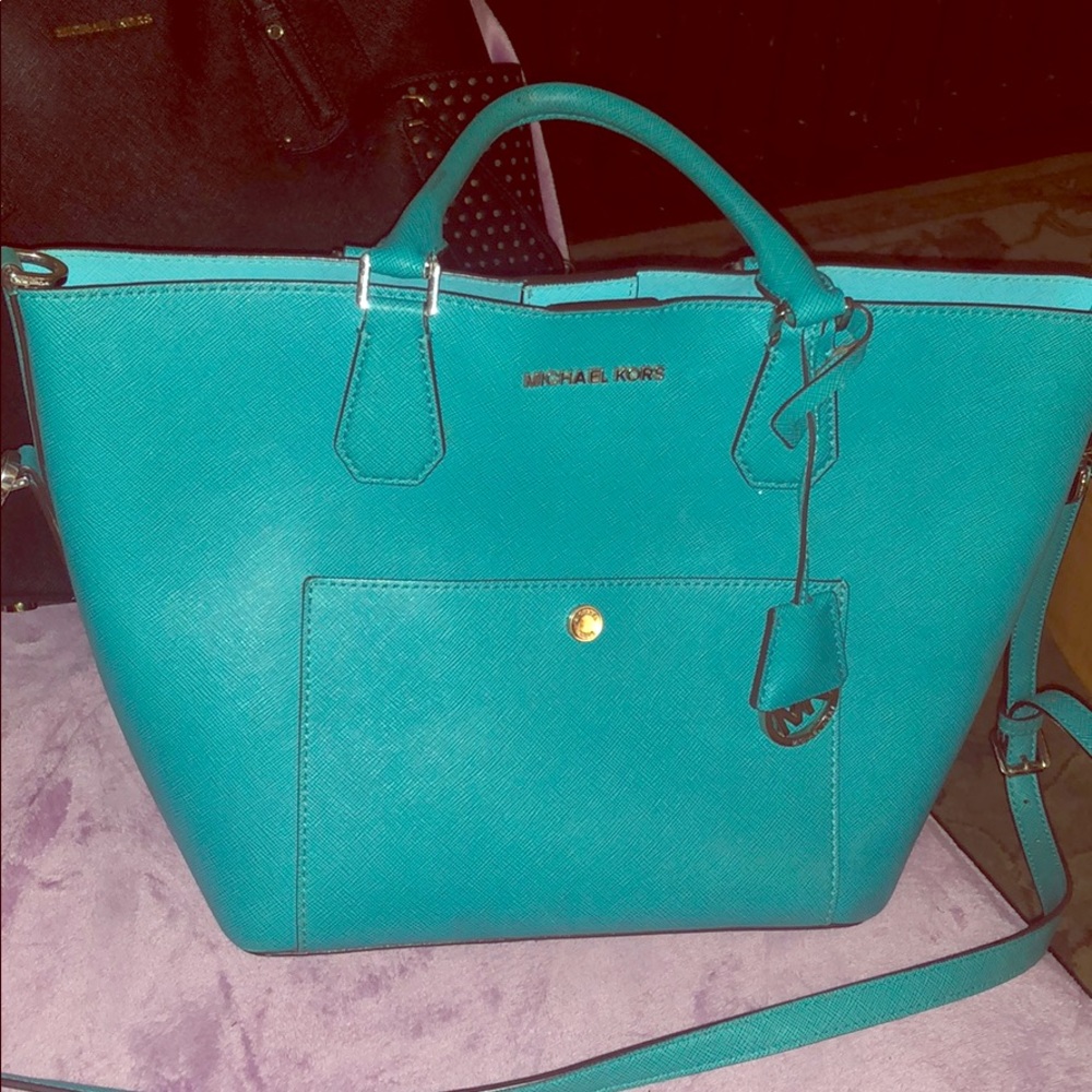 Gently used MK teal large cross body tote purse.